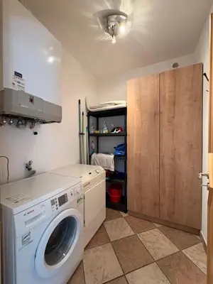 a laundry room with a washing machine and a cabinet at Apartment Apfel in Naturno