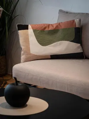 a couch with a pillow on top of a table at Laubennest 1 in Merano