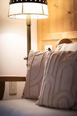 a bedroom with a bed with a lamp on it at Traditional Cozy Apartment in Tirolo