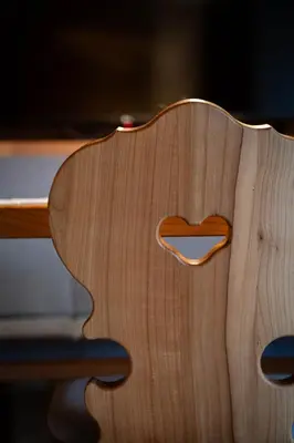 a wooden table with a heart carved into it at Traditional Cozy Apartment in Tirolo