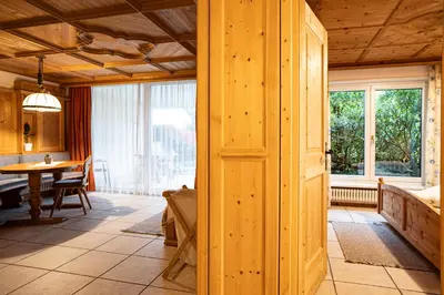 a wooden room with a table and a dining room at Traditional Cozy Apartment in Tirolo