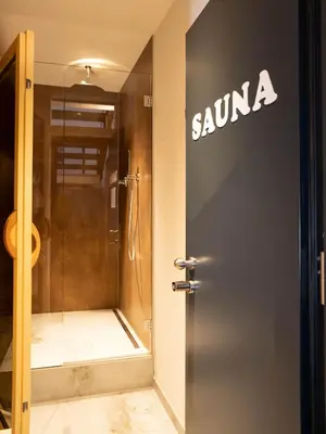 a sign on the door of a bathroom with a shower at Laubennest 2 in Merano