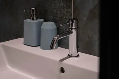 a bathroom sink with a faucet and a soap dispenser at Laubennest 3 in Merano