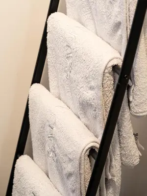 a group of white towels on a towel rack at Laubennest 3 in Merano