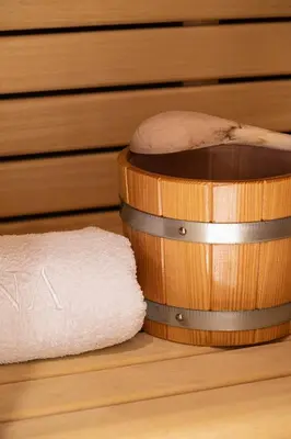 a hamster sitting on top of a wooden barrel with a towel at Laubennest 3 in Merano
