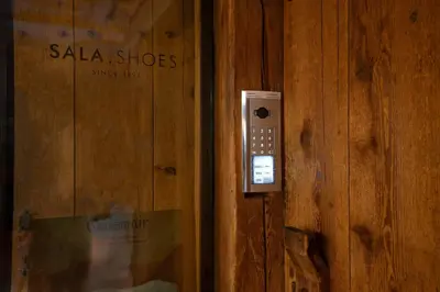 a remote control is attached to a wooden wall at Laubennest 3 in Merano