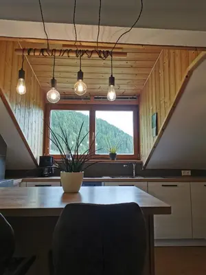 a kitchen with a table and a large window at Haus Maria in Campolasta