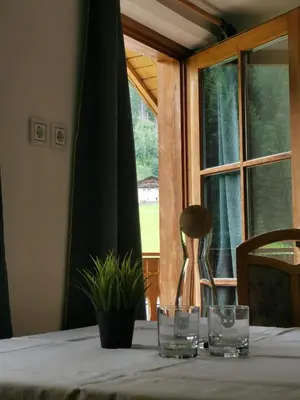 a table with glasses on it with a window at Haus Maria in Campolasta