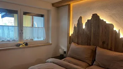 a bedroom with a large bed with towels on it at Appartamento Pampeago n 1 in Stava