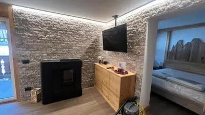 a bathroom with a sink and a toilet and a mirror at Appartamento Pampeago n 1 in Stava
