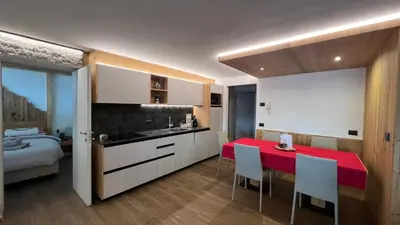 a room with a brick wall with a fireplace and a bed at Appartamento Pampeago n 1 in Stava