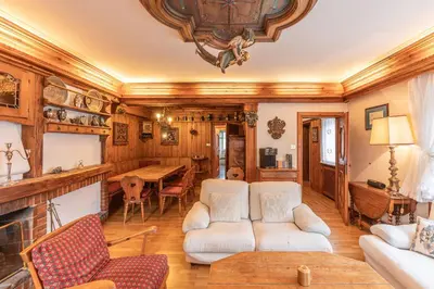 a living room with a couch and a table at Casa via dei Prati, ampia e confortevole in centro in Cortina dʼAmpezzo