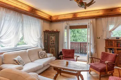 a living room with a couch and a table at Casa via dei Prati, ampia e confortevole in centro in Cortina dʼAmpezzo