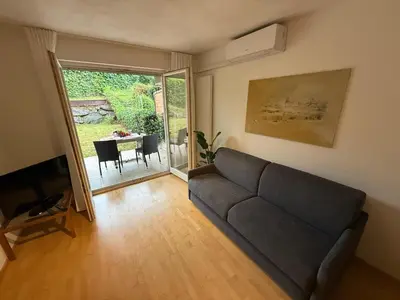 a living room with a couch and a table at MarlingoStar con giardino e garage in Marlengo