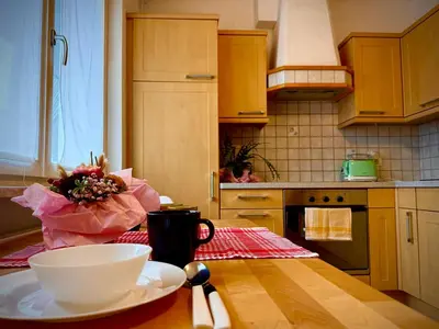 a kitchen with a table with a bowl on a table at MarlingoStar con giardino e garage in Marlengo