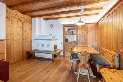 a dining room with wooden walls and a wooden table at Beautiful ground floor flat few steps from centre in Cortina dʼAmpezzo
