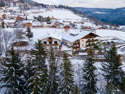 a small town covered in snow with houses at Hotel Restaurant Alber in Verano