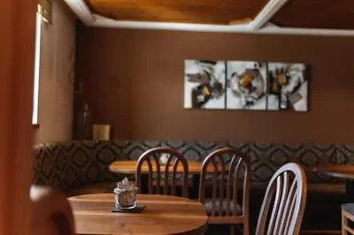 a dining room with a wooden table and chairs at Hotel Restaurant Alber in Verano