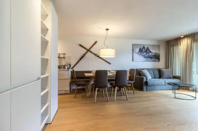 a living room and dining room with a table and chairs at Proventus Apartments in Perca