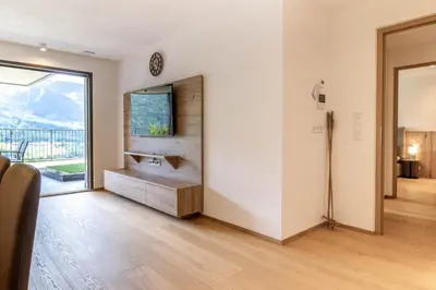 a living room with a television and a large window at Proventus Apartments in Perca