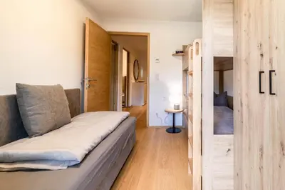a small room with a couch and a bed at Proventus Apartments in Perca