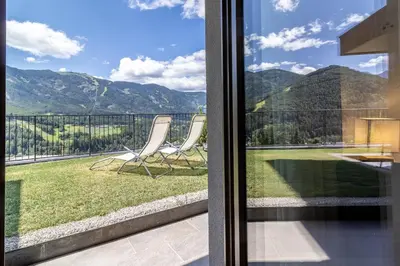 a balcony with chairs and a view of the mountains at Proventus Apartments in Perca