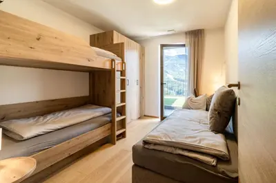 a room with two bunk beds and a window at Proventus Apartments in Perca