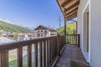 a house with a balcony on top of it at Alpine Heart in Falcade