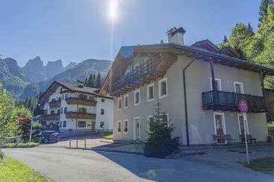 an empty street in front of a building at Alpine Heart in Falcade