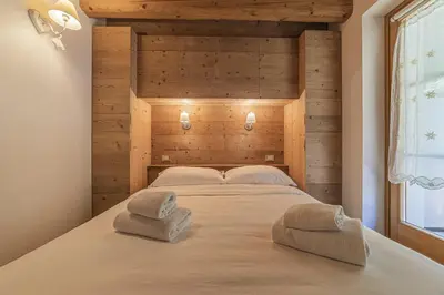 a room with three bunk beds in a cabin at Alpine Heart in Falcade