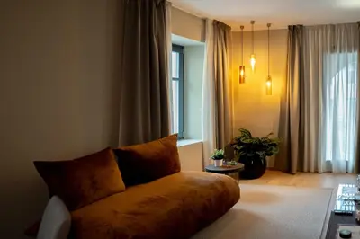 a living room with a couch and a window at KODERLE SUITE K1 Bucaneve in Brunico