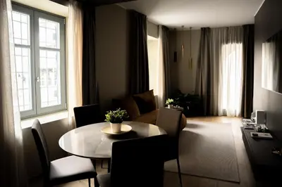 a living room with a table and a living room with a couch at KODERLE SUITE K1 Bucaneve in Brunico
