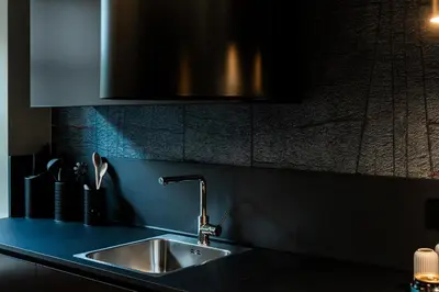 a kitchen counter with a stainless steel sink at Koderle Suite K2 Arnica in Brunico