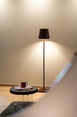 a cup of coffee on a table next to a lamp at Koderle Suite K2 Arnica in Brunico