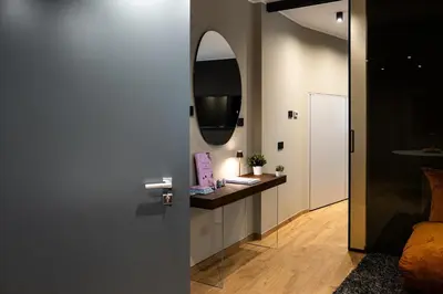 a hallway with a vanity and a mirror at Koderle Suite K2 Arnica in Brunico