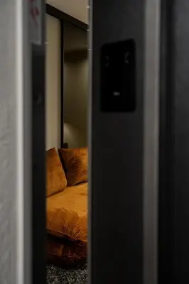 a reflection of a couch in a mirror at Koderle Suite K2 Arnica in Brunico