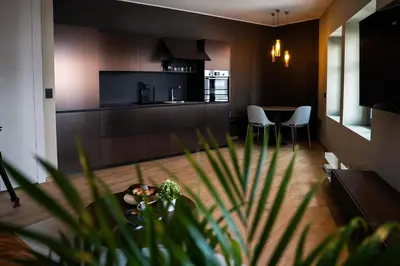 a kitchen and dining room with a table and chairs at KODERLE SUITE K4 Zampa D Orso in Brunico