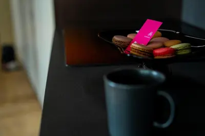 a plate of cookies and a cup on a counter at KODERLE SUITE K4 Zampa D Orso in Brunico