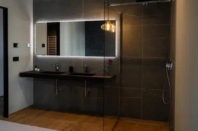a bathroom with a sink and a mirror at KODERLE SUITE K4 Zampa D Orso in Brunico