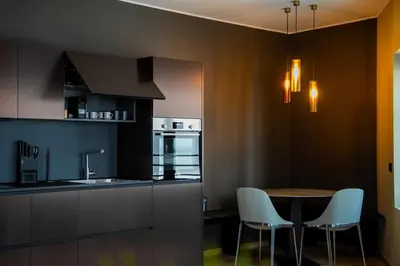 a kitchen with a table and chairs and a sink at KODERLE SUITE K4 Zampa D Orso in Brunico