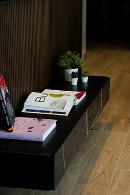 a black table with books and potted plants on it at KODERLE SUITE K3 Genziana in Brunico