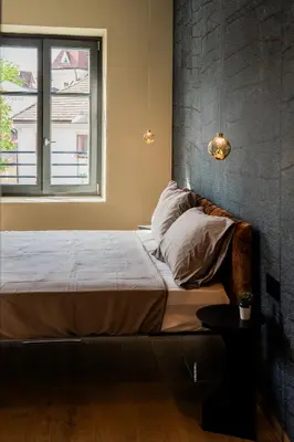 a bed in a room with a window at KODERLE SUITE K3 Genziana in Brunico
