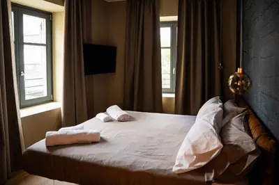a bedroom with a bed with two pillows on it at KODERLE SUITE K3 Genziana in Brunico