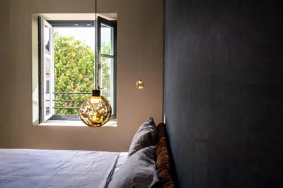 a bedroom with a bed and a window at KODERLE SUITE K3 Genziana in Brunico