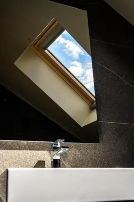 a bathroom mirror with a window above a sink at KODERLE SUITE K5 Stella Alpina in Brunico