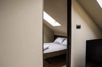 a bedroom with a bed and a mirror at KODERLE SUITE K5 Stella Alpina in Brunico