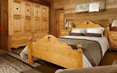a bedroom with two beds in a log cabin at Gianni's Home2 Santa Cristina VG in Santa Cristina in Val Gardena