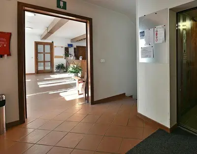 an office hallway with a door open to a room with aoice at Gianni's Home2 Santa Cristina VG in Santa Cristina in Val Gardena