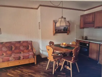 a kitchen with a table and chairs and a couch at Gianni's Home2 Santa Cristina VG in Santa Cristina in Val Gardena
