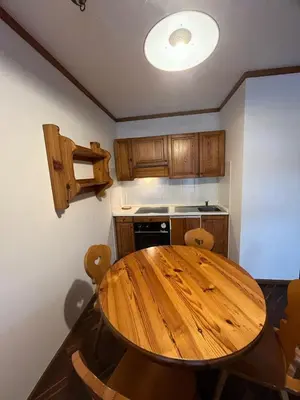 a kitchen with a wooden table in a kitchen at Gianni's Home2 Santa Cristina VG in Santa Cristina in Val Gardena